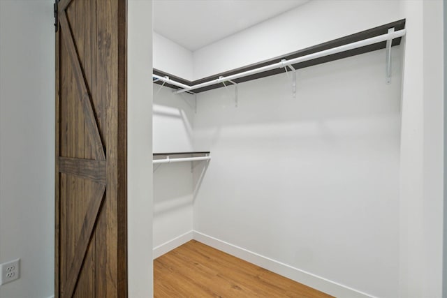 330 Canfield St, Milan, MI 48160 - spacious closet with a barn door and hardwood / wood-style flooring