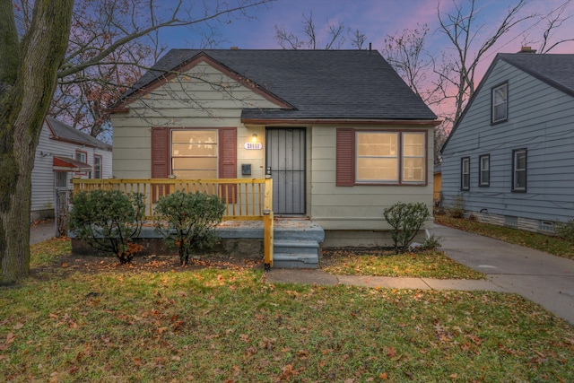 bungalow-style house featuring a yard