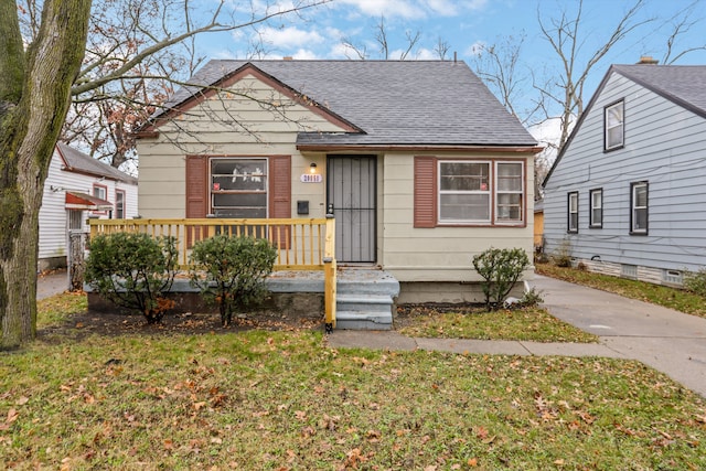 bungalow-style home with a front lawn