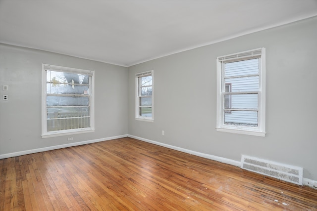 unfurnished room with hardwood / wood-style flooring