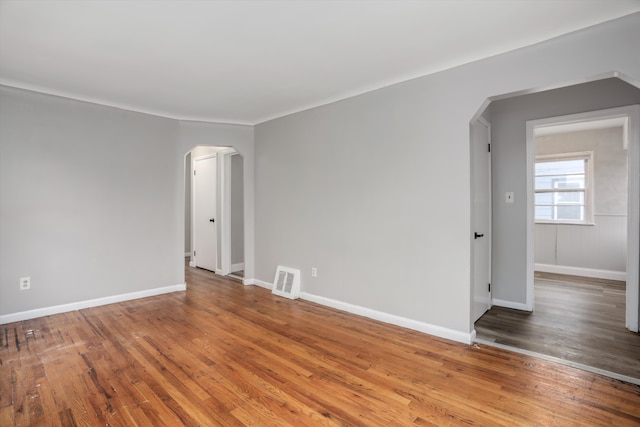 unfurnished room with wood-type flooring