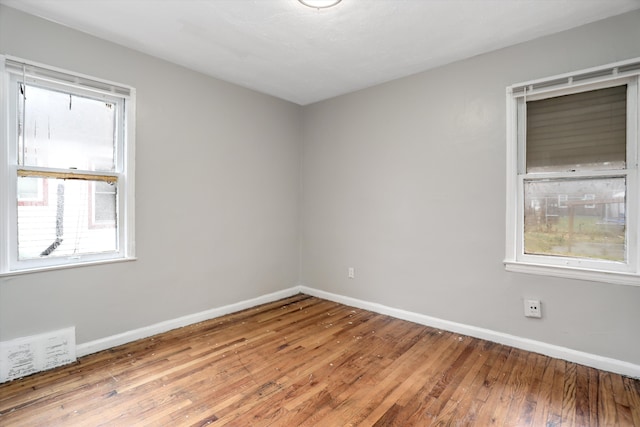 spare room with wood-type flooring