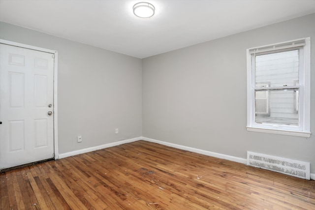 unfurnished room with hardwood / wood-style flooring