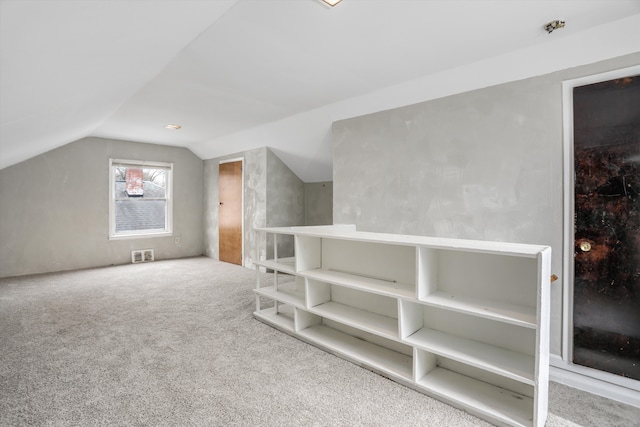 additional living space featuring carpet flooring and lofted ceiling