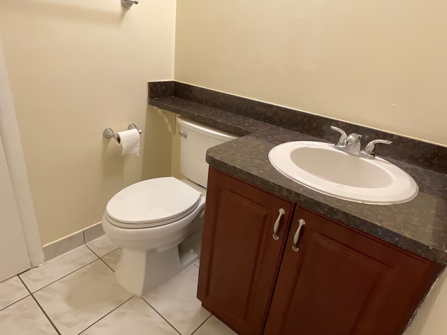 bathroom featuring tile patterned flooring, vanity, and toilet