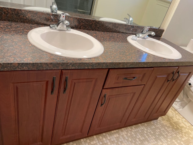 bathroom featuring tile patterned flooring and vanity