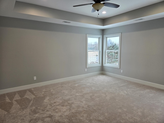 carpeted spare room featuring ceiling fan