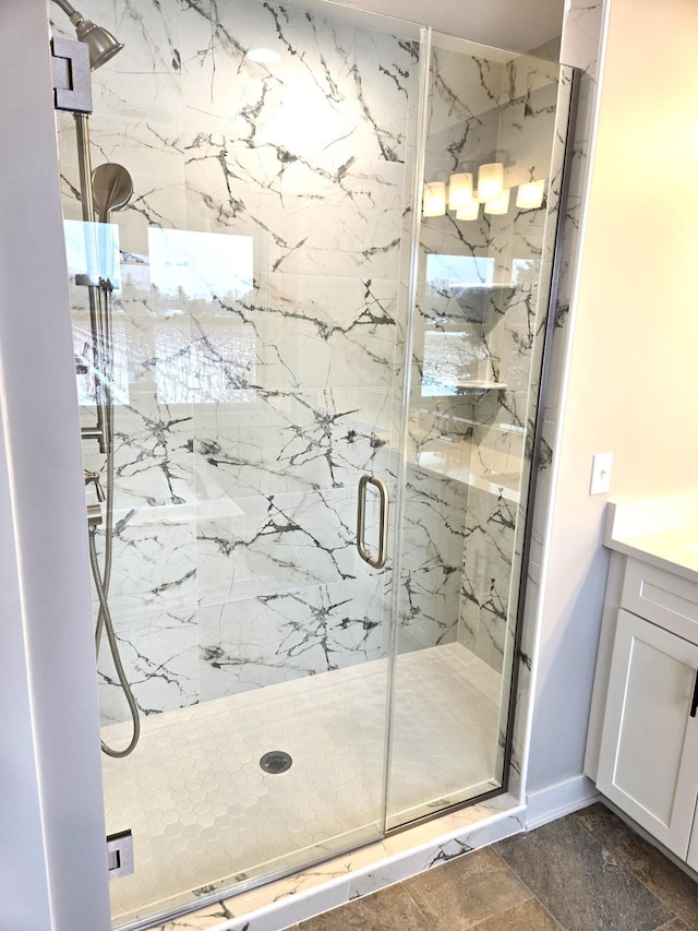 bathroom with vanity and a shower with shower door