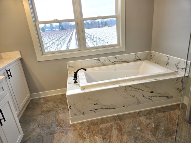 bathroom featuring vanity and a relaxing tiled tub