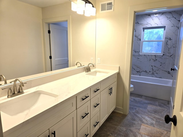 full bathroom with vanity, toilet, and tiled shower / bath