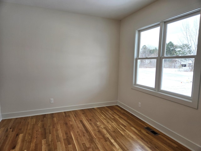 unfurnished room with dark hardwood / wood-style floors