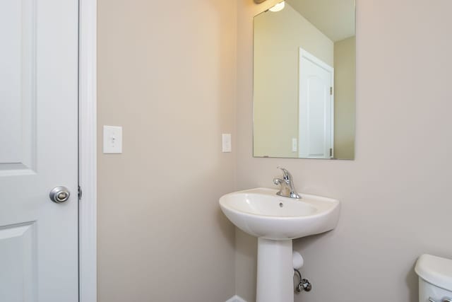 bathroom with toilet and sink