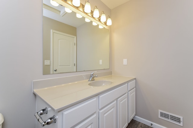 bathroom with hardwood / wood-style floors and vanity