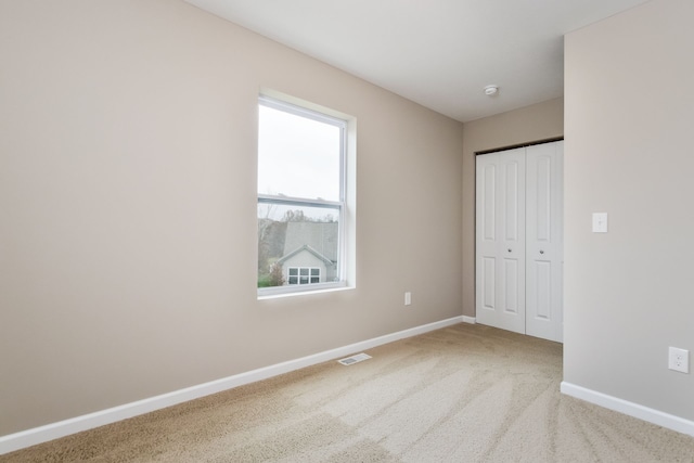 unfurnished bedroom featuring a closet and carpet