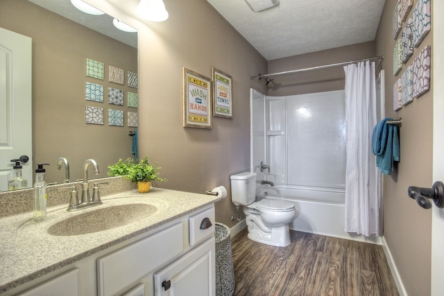 full bathroom with a textured ceiling, vanity, shower / tub combo with curtain, hardwood / wood-style flooring, and toilet