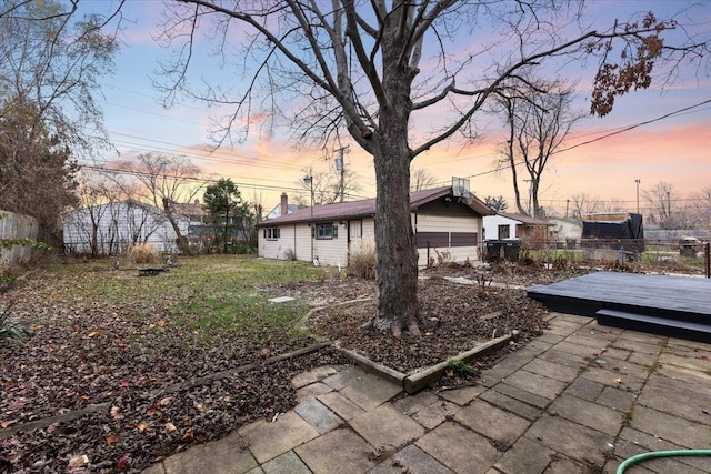 view of yard featuring a wooden deck and fence