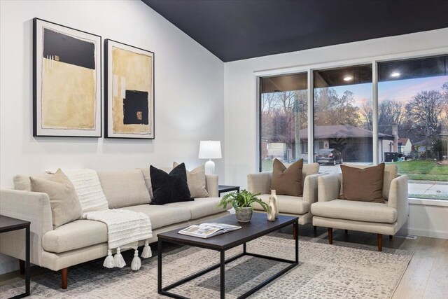 living room with vaulted ceiling and light hardwood / wood-style flooring