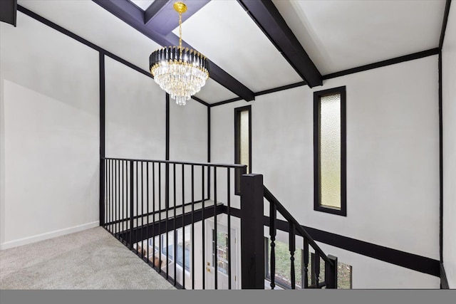 interior space with a notable chandelier, beamed ceiling, carpet flooring, and baseboards