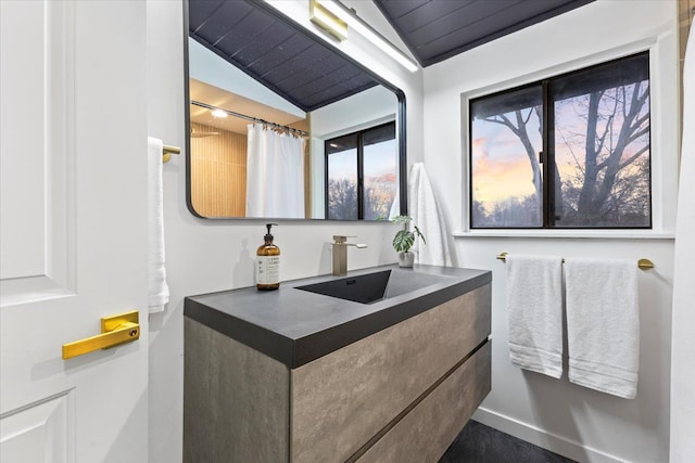 bathroom with vanity and lofted ceiling