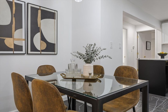 dining space featuring marble finish floor