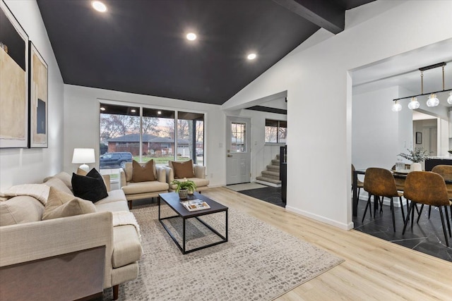 living area with stairway, wood finished floors, baseboards, vaulted ceiling with beams, and recessed lighting