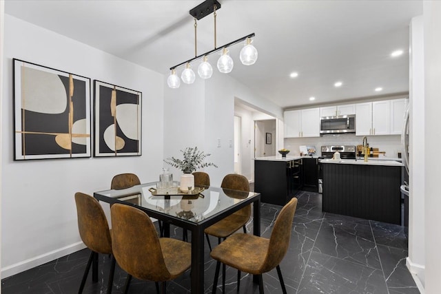 dining area with recessed lighting, marble finish floor, and baseboards