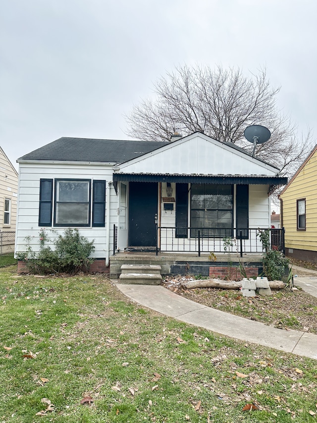 view of front of property with a front yard and covered porch