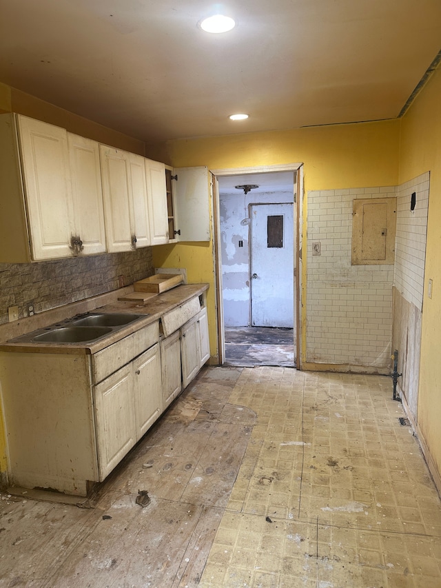 kitchen featuring white cabinets and sink