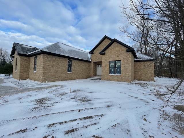 view of snow covered rear of property