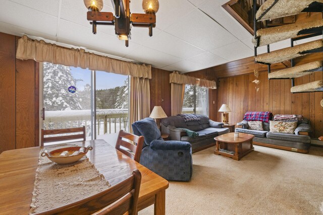 living room with carpet and wooden walls