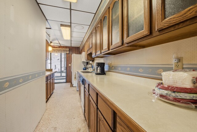 kitchen with light carpet, white refrigerator, a drop ceiling, and sink