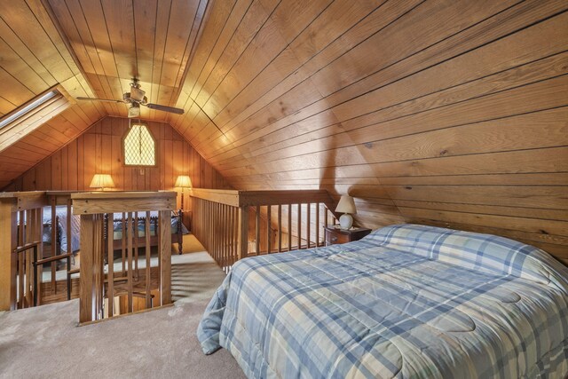 bedroom featuring wooden ceiling, carpet floors, wooden walls, and lofted ceiling with skylight