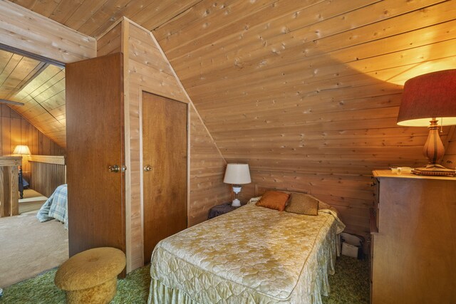 bedroom with vaulted ceiling, carpet floors, wooden walls, and wooden ceiling