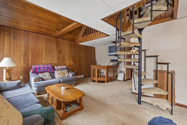 carpeted living room with wooden walls