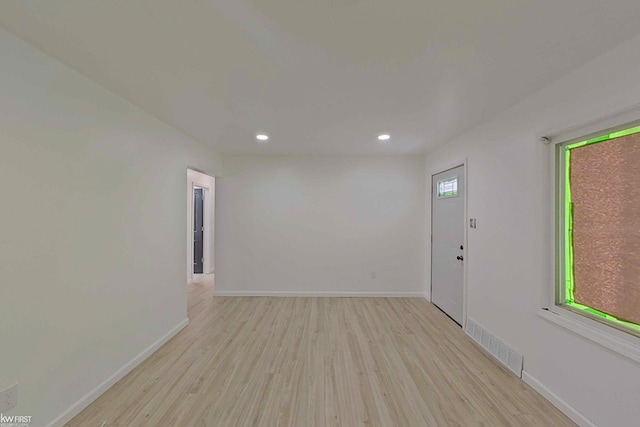 empty room featuring light wood-type flooring and a wealth of natural light