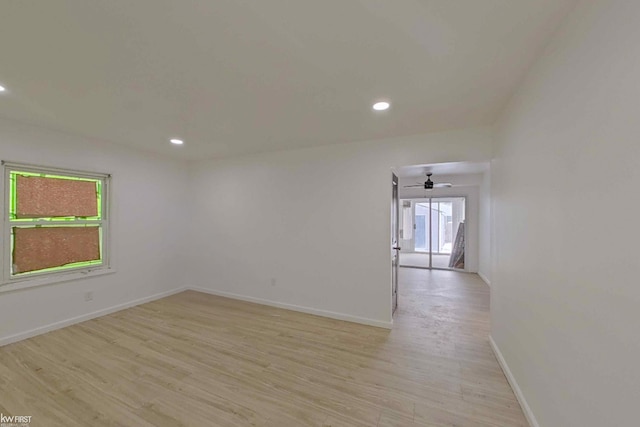 unfurnished room featuring a wealth of natural light, ceiling fan, and light hardwood / wood-style floors