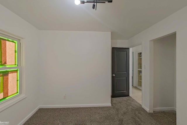 carpeted spare room with plenty of natural light