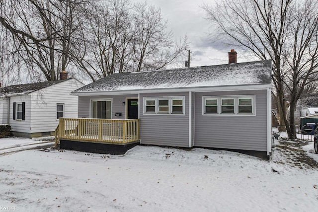 view of snow covered back of property