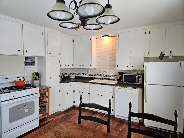 kitchen featuring white cabinetry, sink, tasteful backsplash, dark hardwood / wood-style flooring, and white appliances