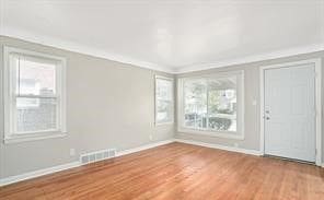 interior space featuring hardwood / wood-style floors and ornamental molding