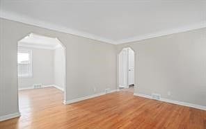 unfurnished room featuring light hardwood / wood-style flooring and ornamental molding