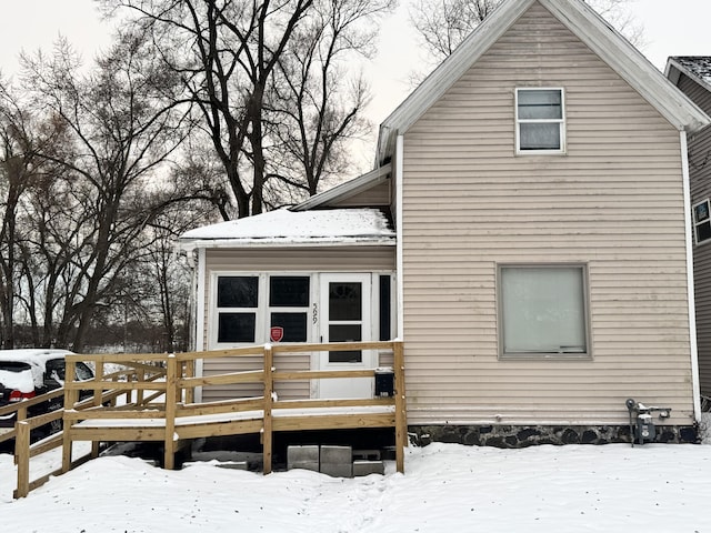 snow covered property featuring a deck