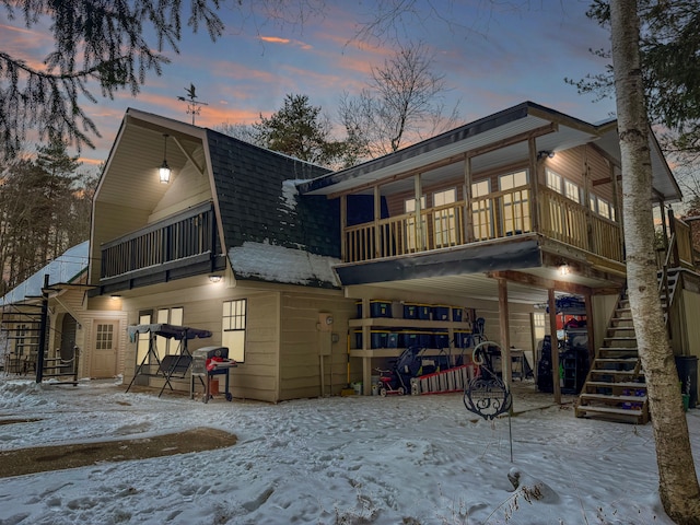 view of snow covered rear of property