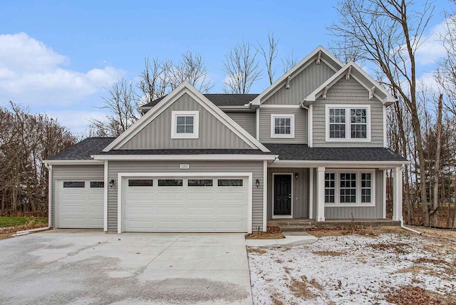 view of front facade featuring board and batten siding, driveway, a shingled roof, and an attached garage