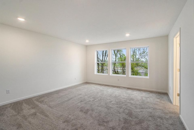 carpeted spare room with baseboards and recessed lighting