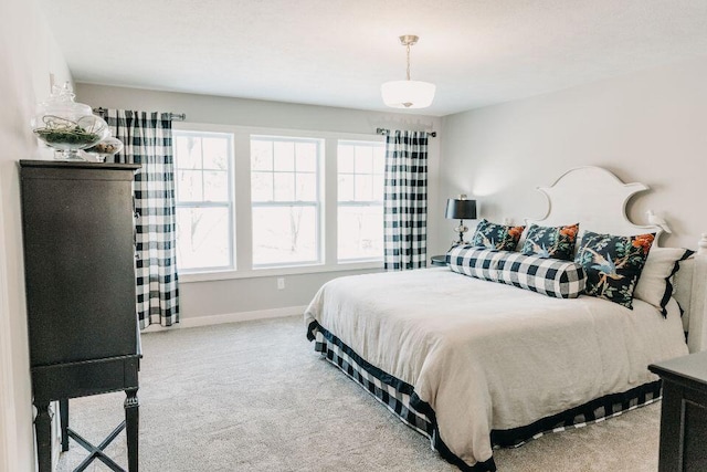 bedroom featuring carpet floors and baseboards