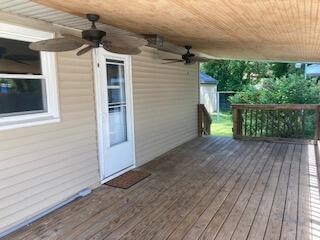 wooden deck featuring ceiling fan