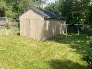 view of outbuilding featuring a lawn