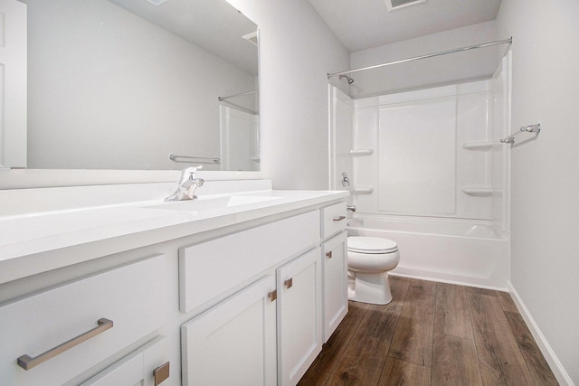 8775 E Sturtevant Ave, Richland, MI 49083 - bathroom featuring wood finished floors, toilet, vanity, washtub / shower combination, and baseboards