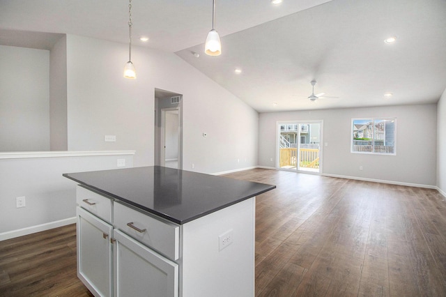 8775 E Sturtevant Ave, Richland, MI 49083 - kitchen featuring a ceiling fan, dark wood-type flooring, dark countertops, a center island, and white cabinets